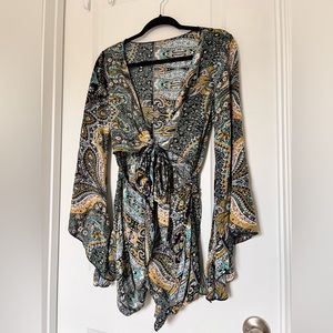 Flowy loose fitting romper. Adjustable top with ties